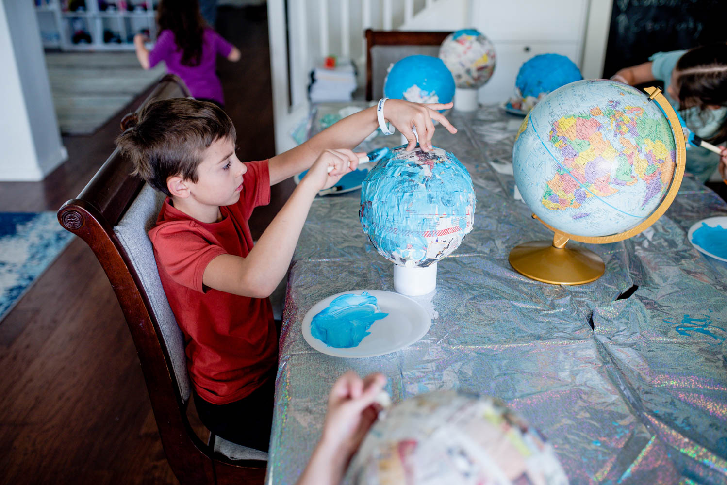 students creating a globe art project