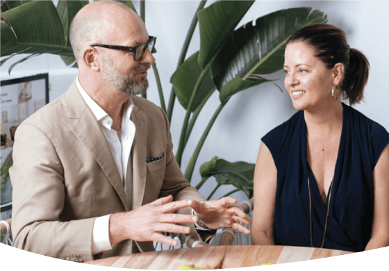 A man and a woman sitting at a table having a friendly meeting