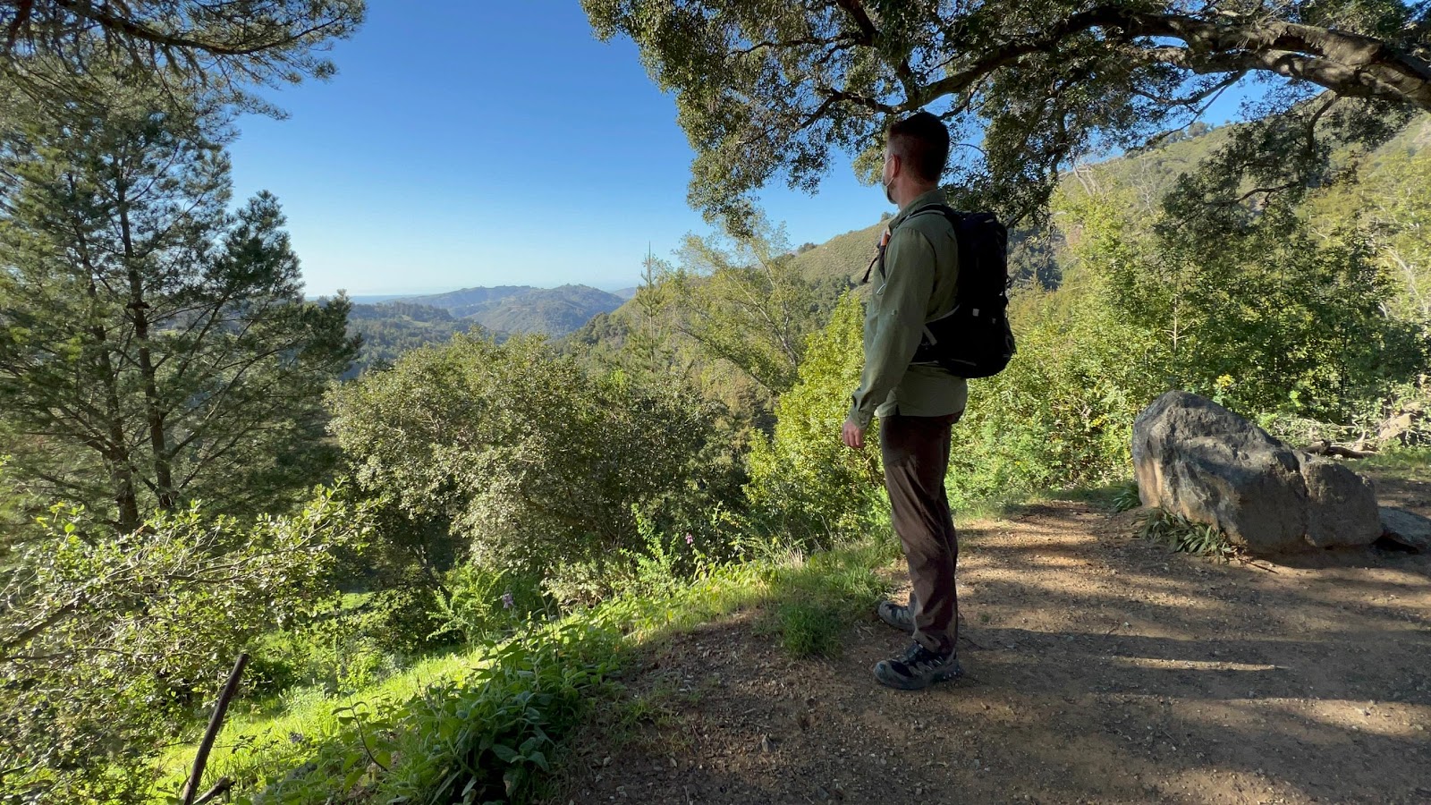 A person walking on a dirt pathDescription automatically generated with low confidence