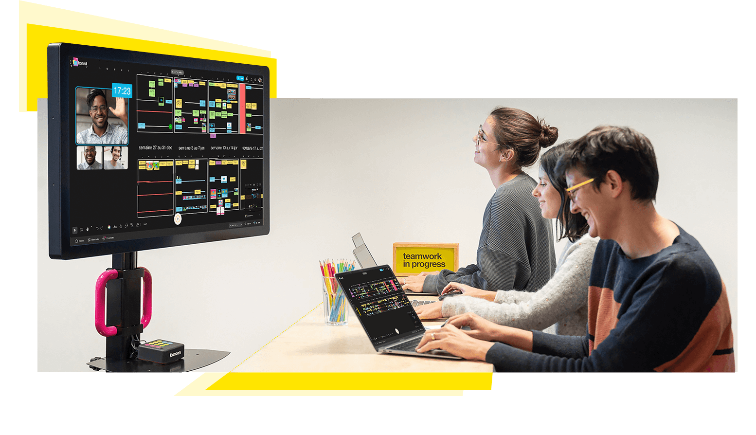 Three colleagues work on a connected screen