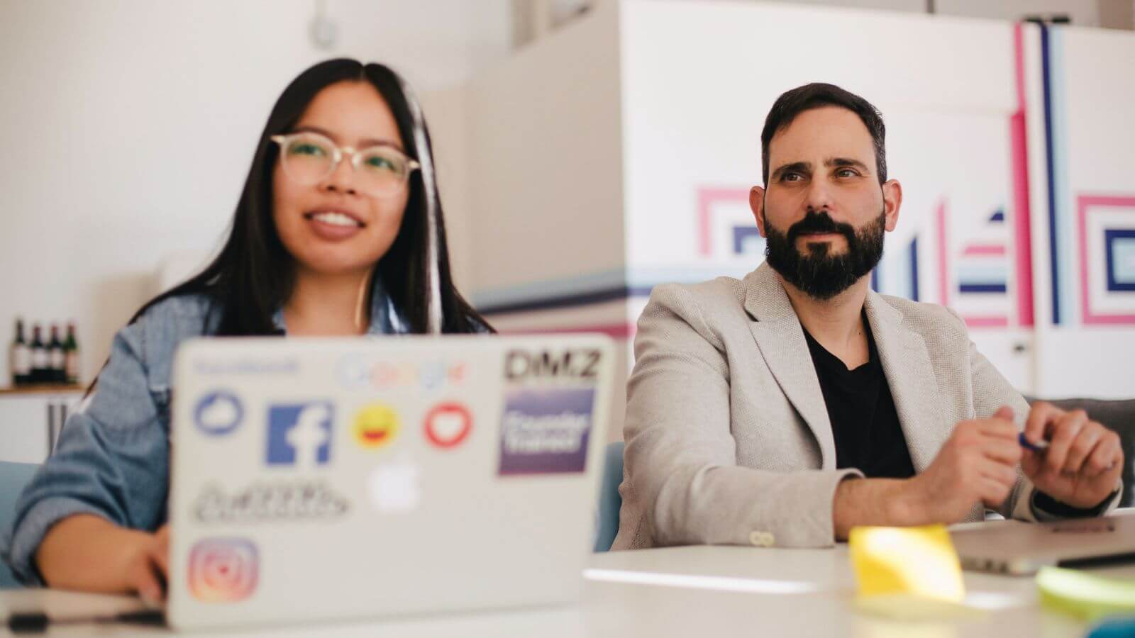Woman and man working and looking at presentation