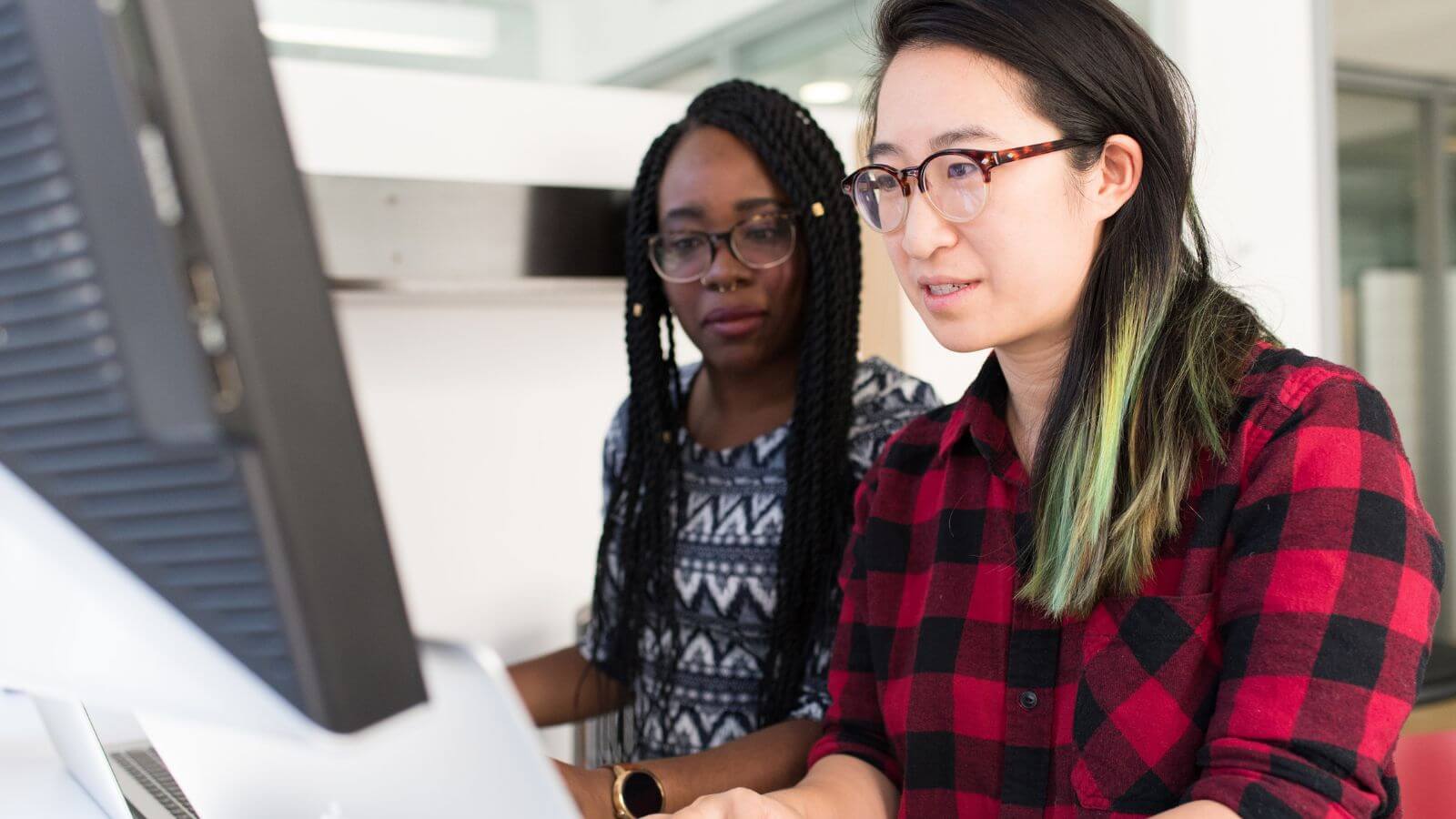 Two women working at computer
