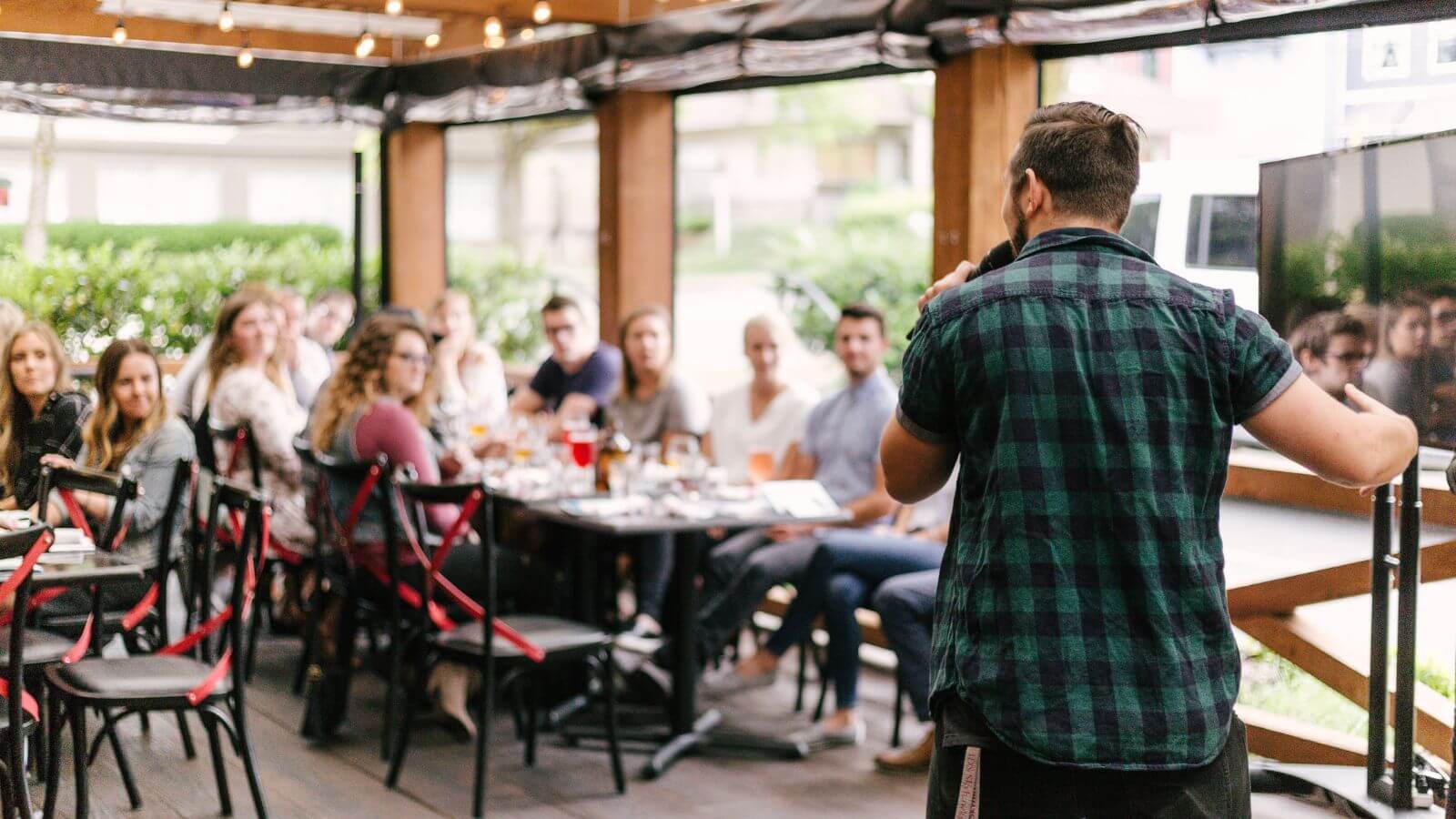 Man presenting at outdoor dinner event