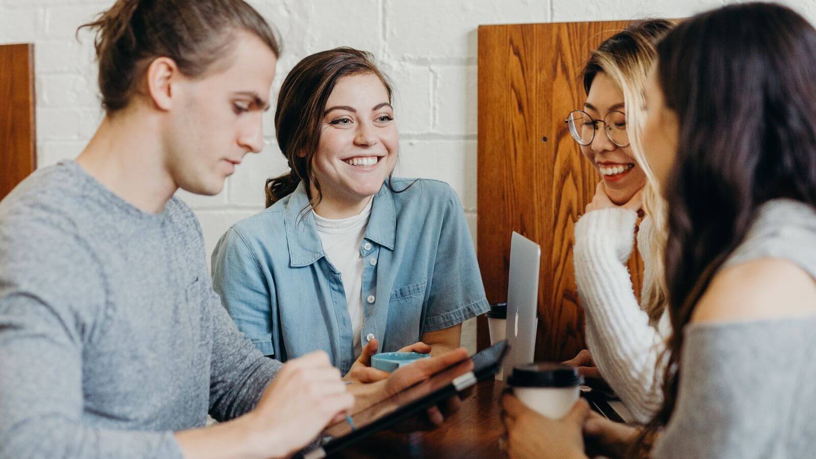 Four people meeting over coffee