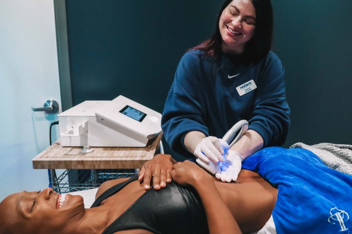 Woman receiving cryoskin treatment on stomach.