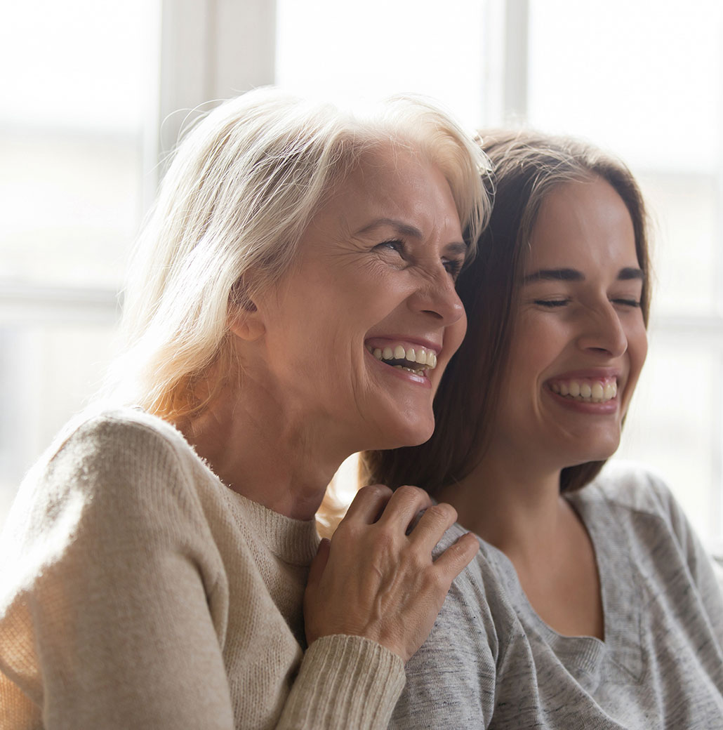 older woman smiling with granddaughter