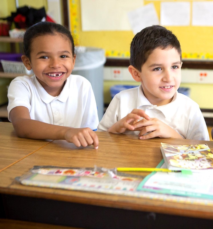 Two boys in a young leaders school smiling for the camera