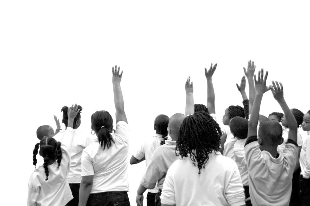 people raising their hands to the sky