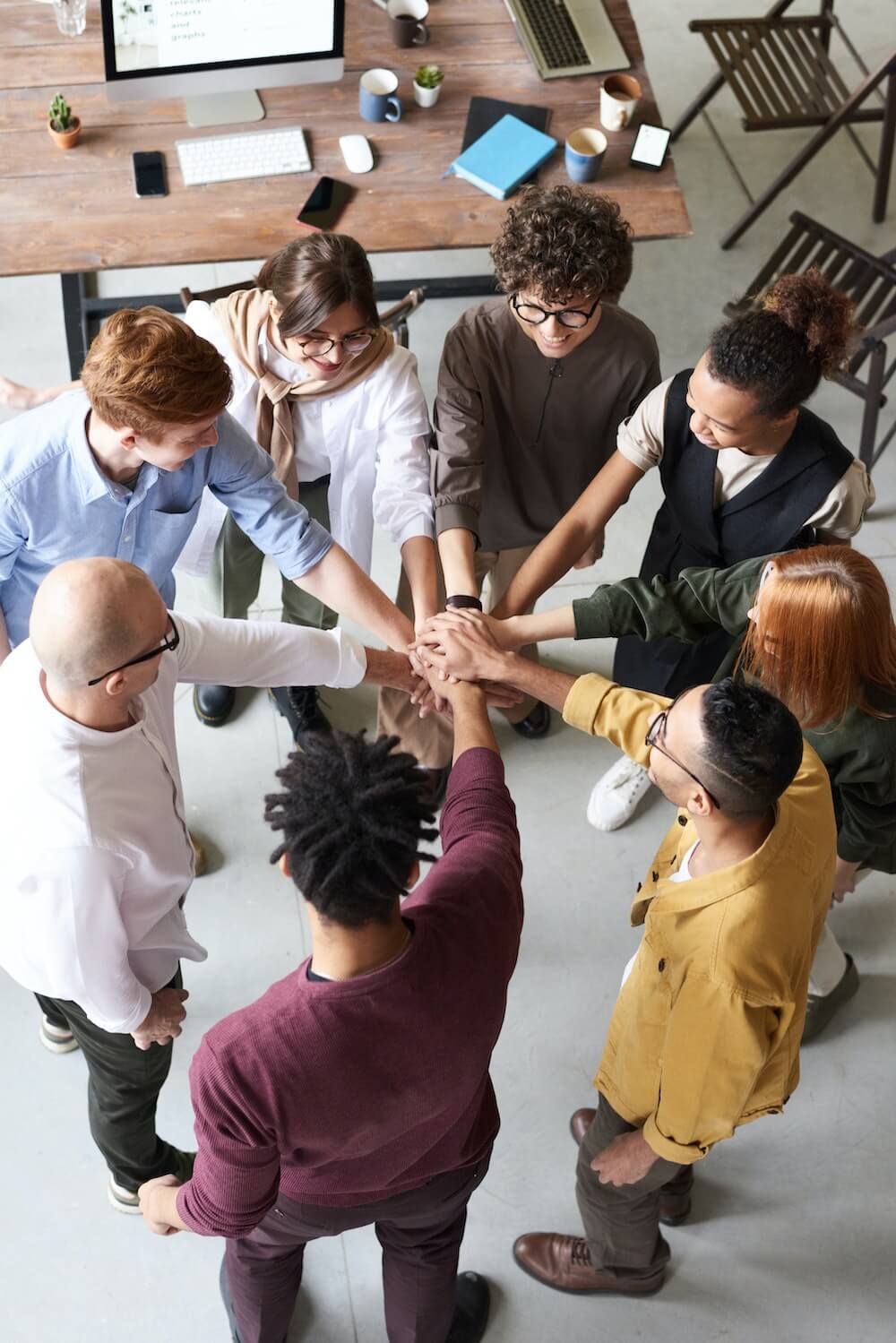 Group of people joining hand in the center