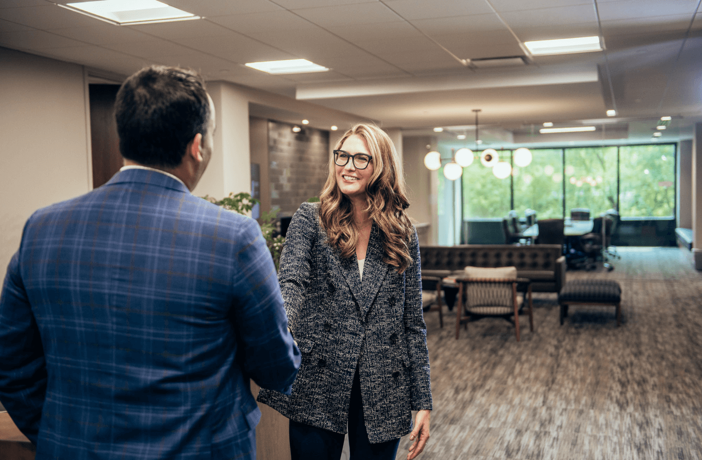 Christensen Group Insurance agent shaking hands with a client in the front foyer of the office