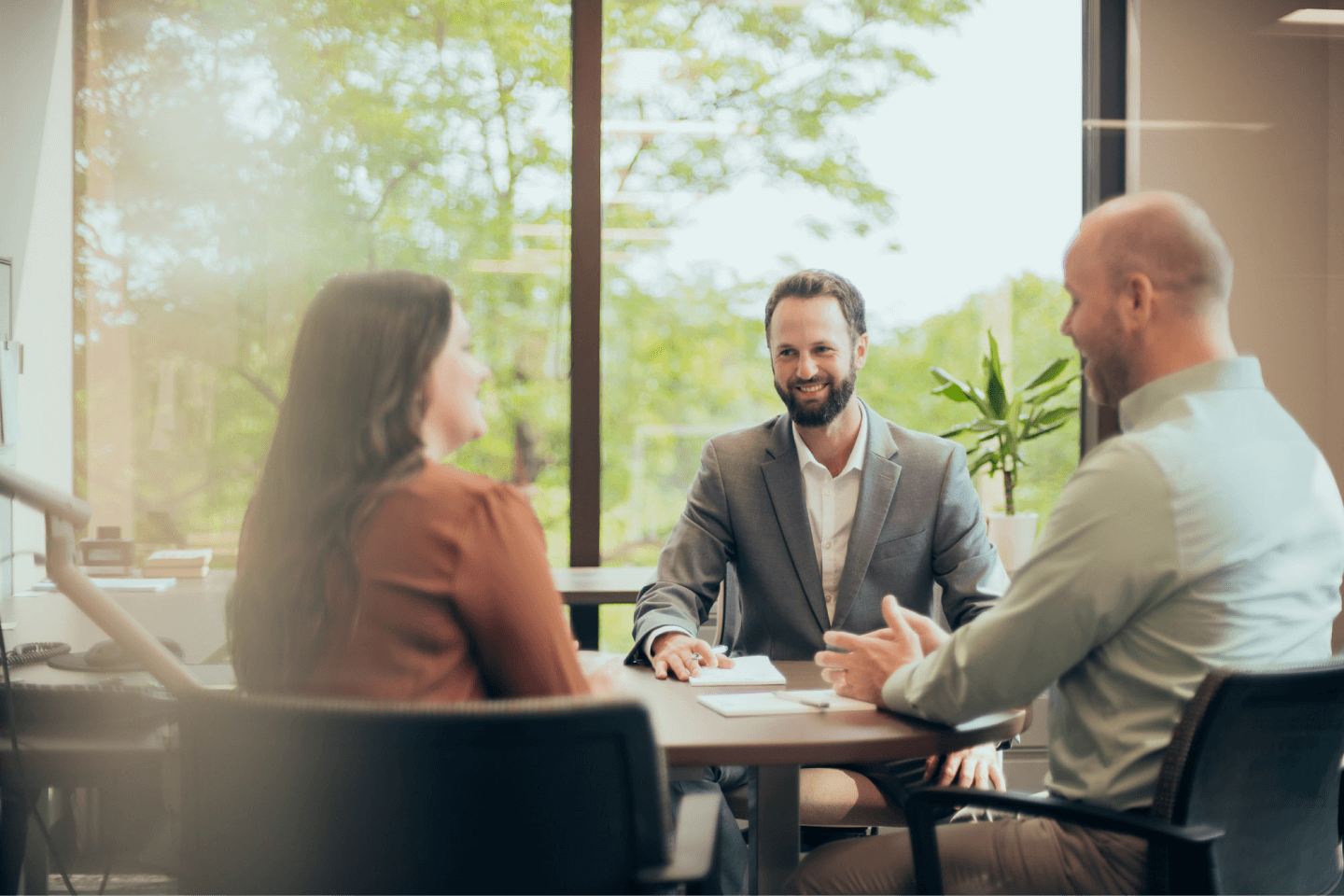 Christensen Group Insurance agent meeting with two people in an office