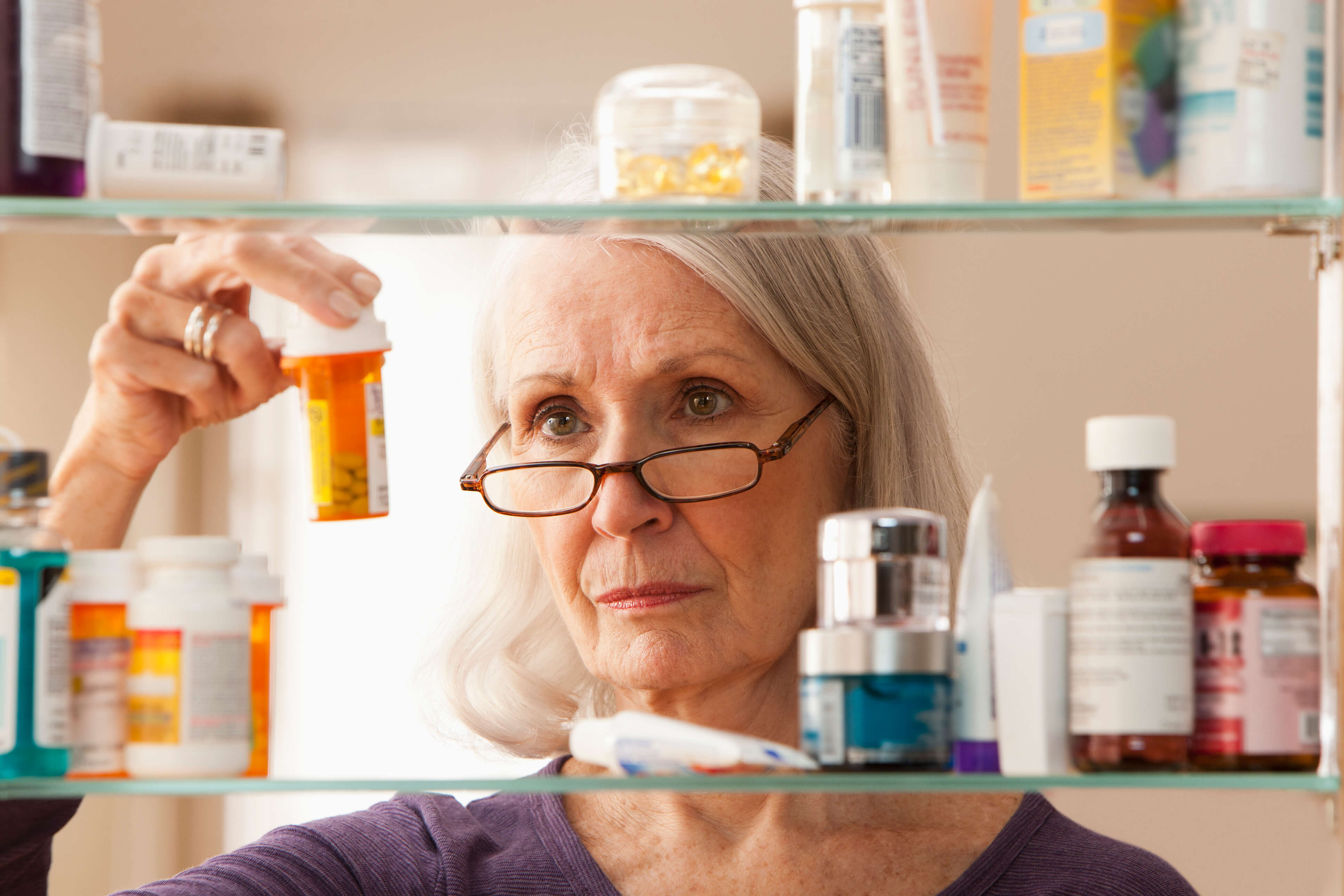 Woman looking at medication pot