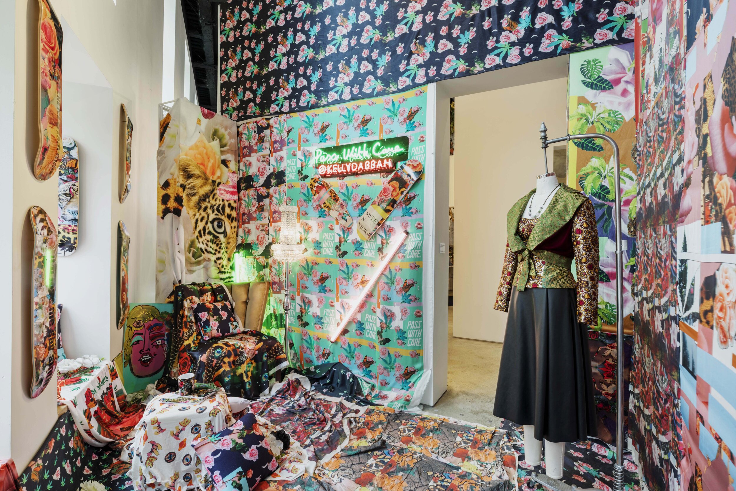 Experience where nature meets city in visual artist Kelly Dabbah’s space through digital prints and original graphics showcased across skateboards, pillows, mugs, and pouches.