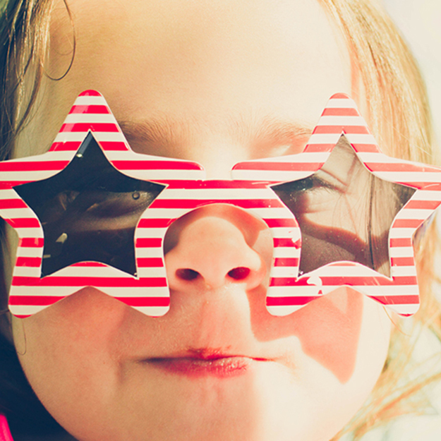 A child with vibrant star glasses