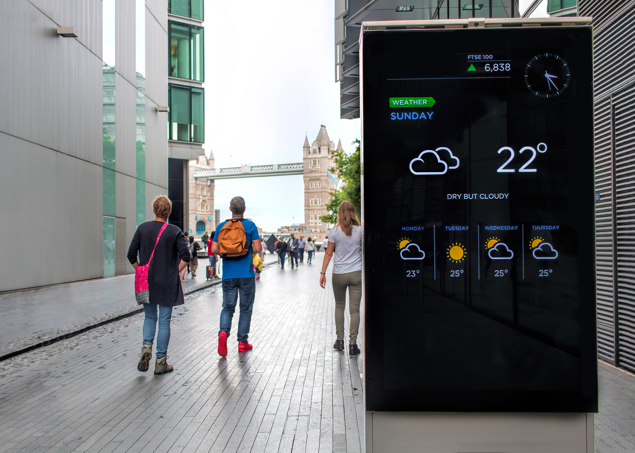 Smart screen showing time and weather down a street