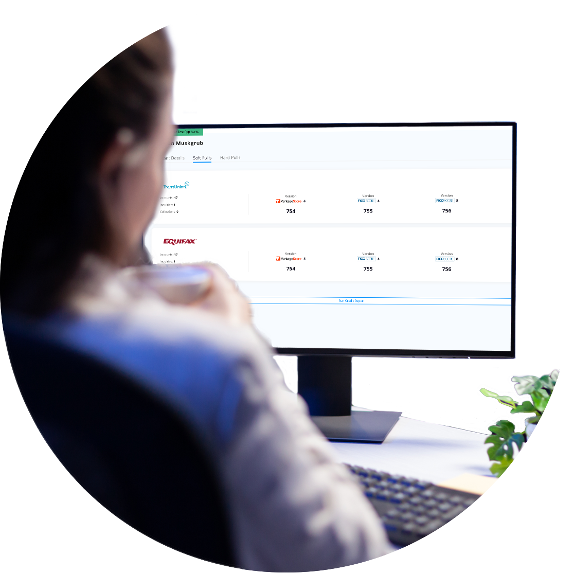 woman looking at computer with iSoftpull credit check platform displayed on monitor
