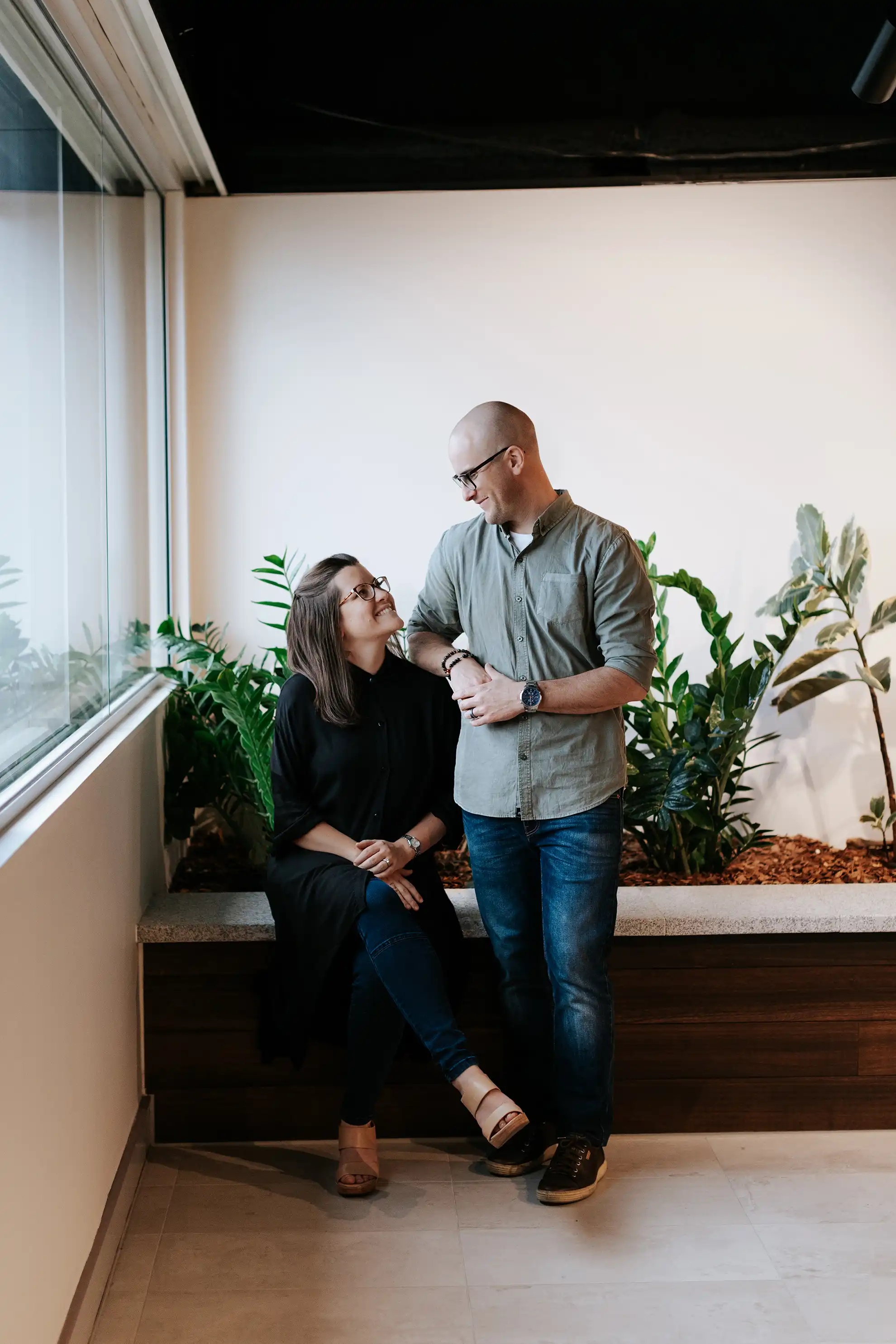 Amanda and Rory, Co-founders of TCN, smiling at each other while they discuss all things graphic design Brisbane.