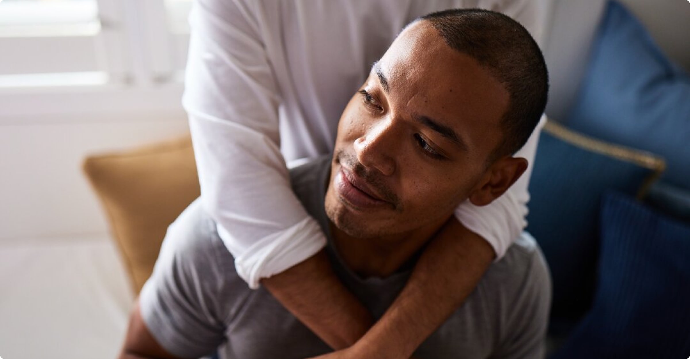 Man hugged by his girlfriend