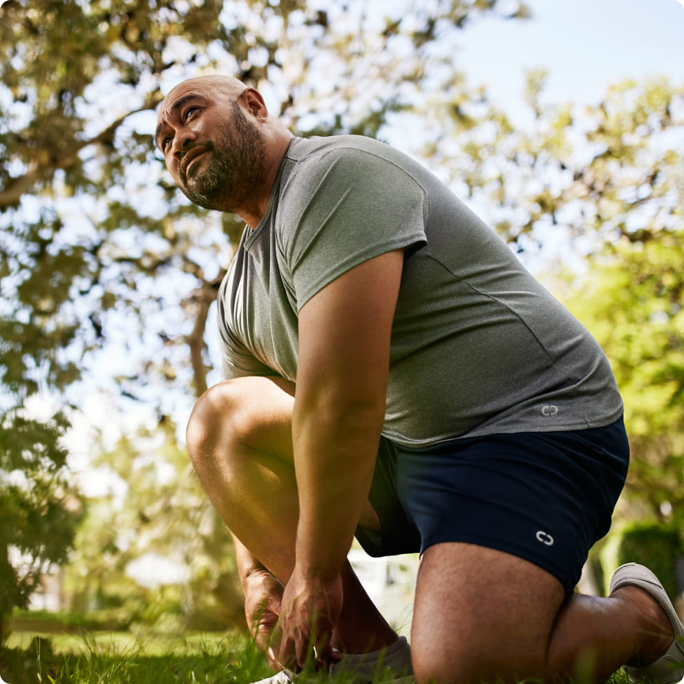 Man tying his shoes during a run