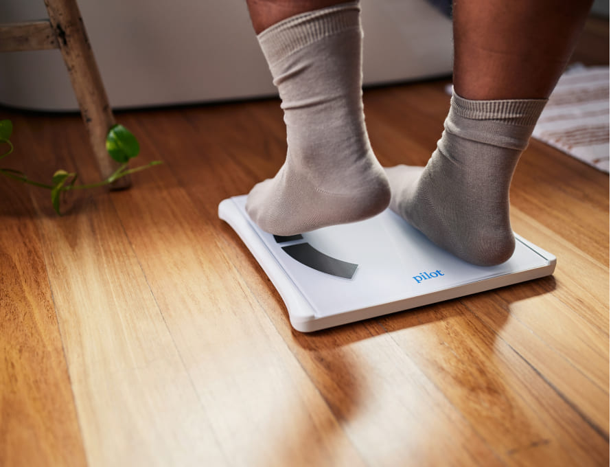 Man stepping on a weight scale