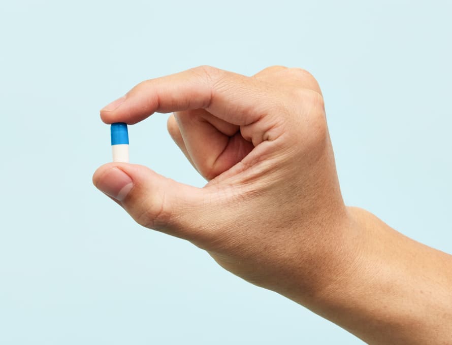 Hand holding a pill