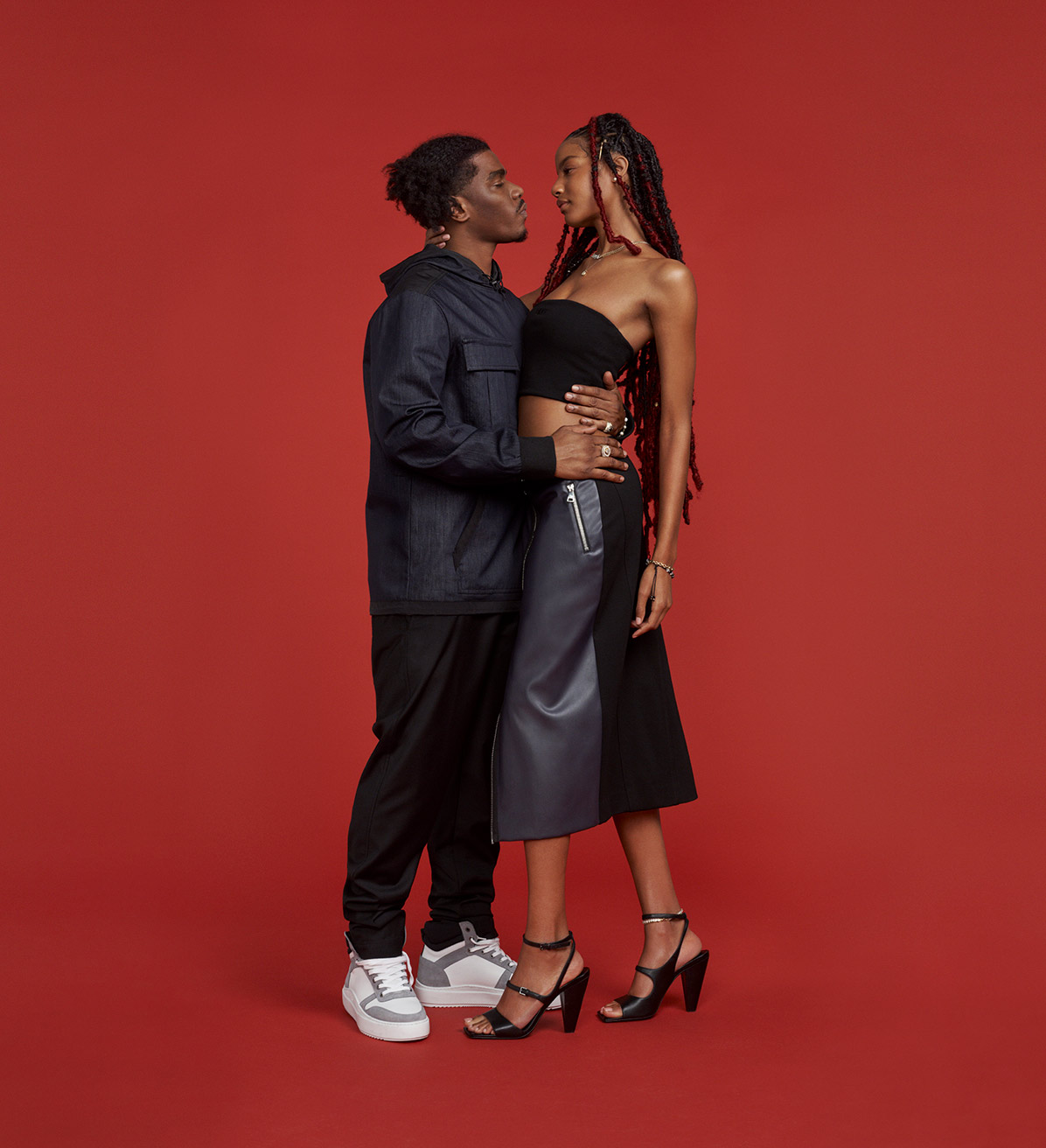 DKNY male and female models with red background