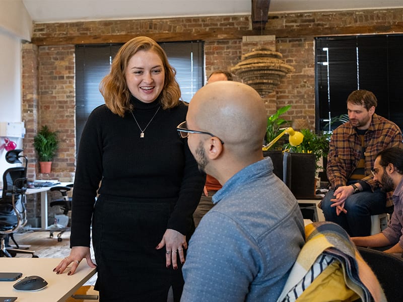 Colleagues chatting in the office.