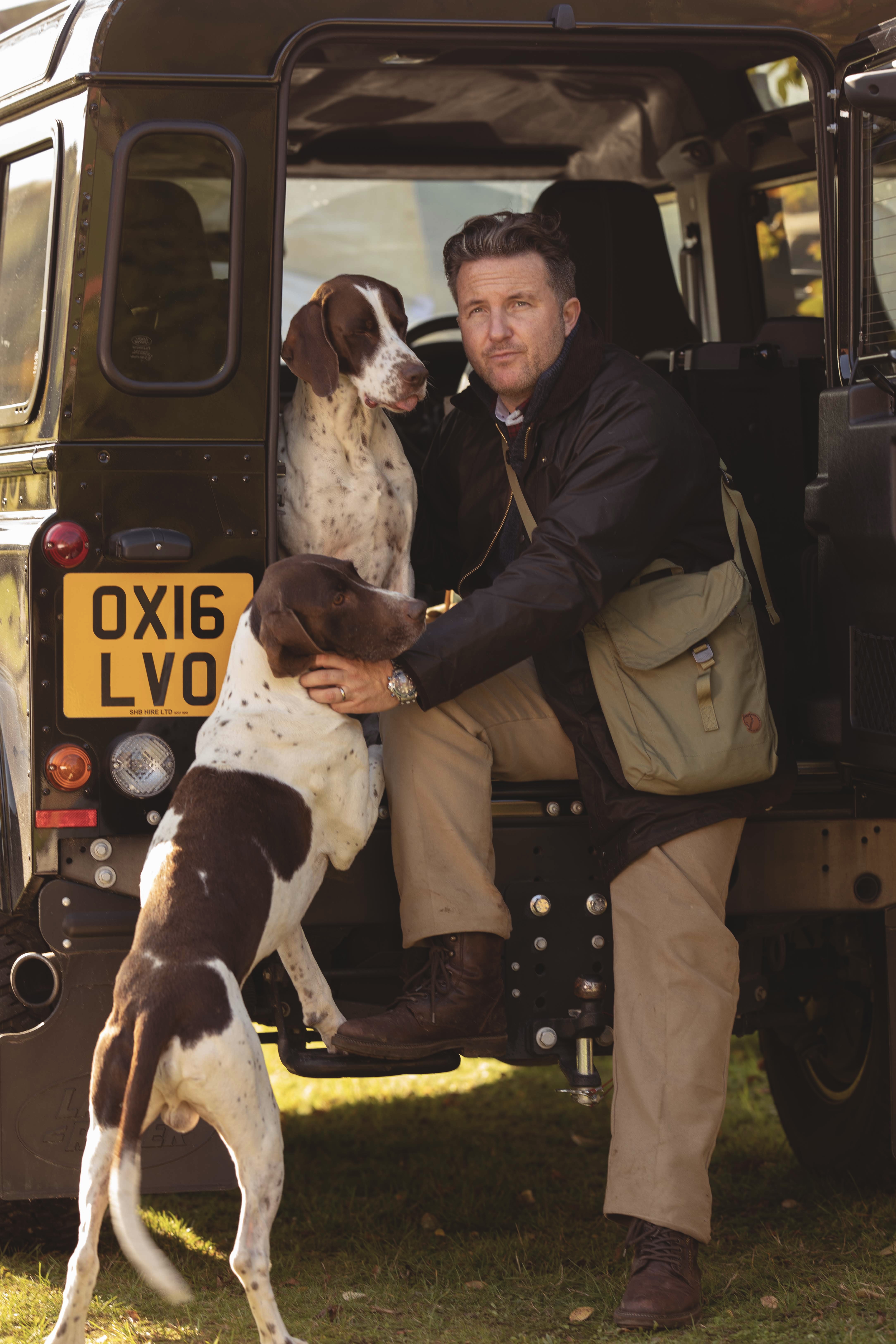 Man with two dogs and a car