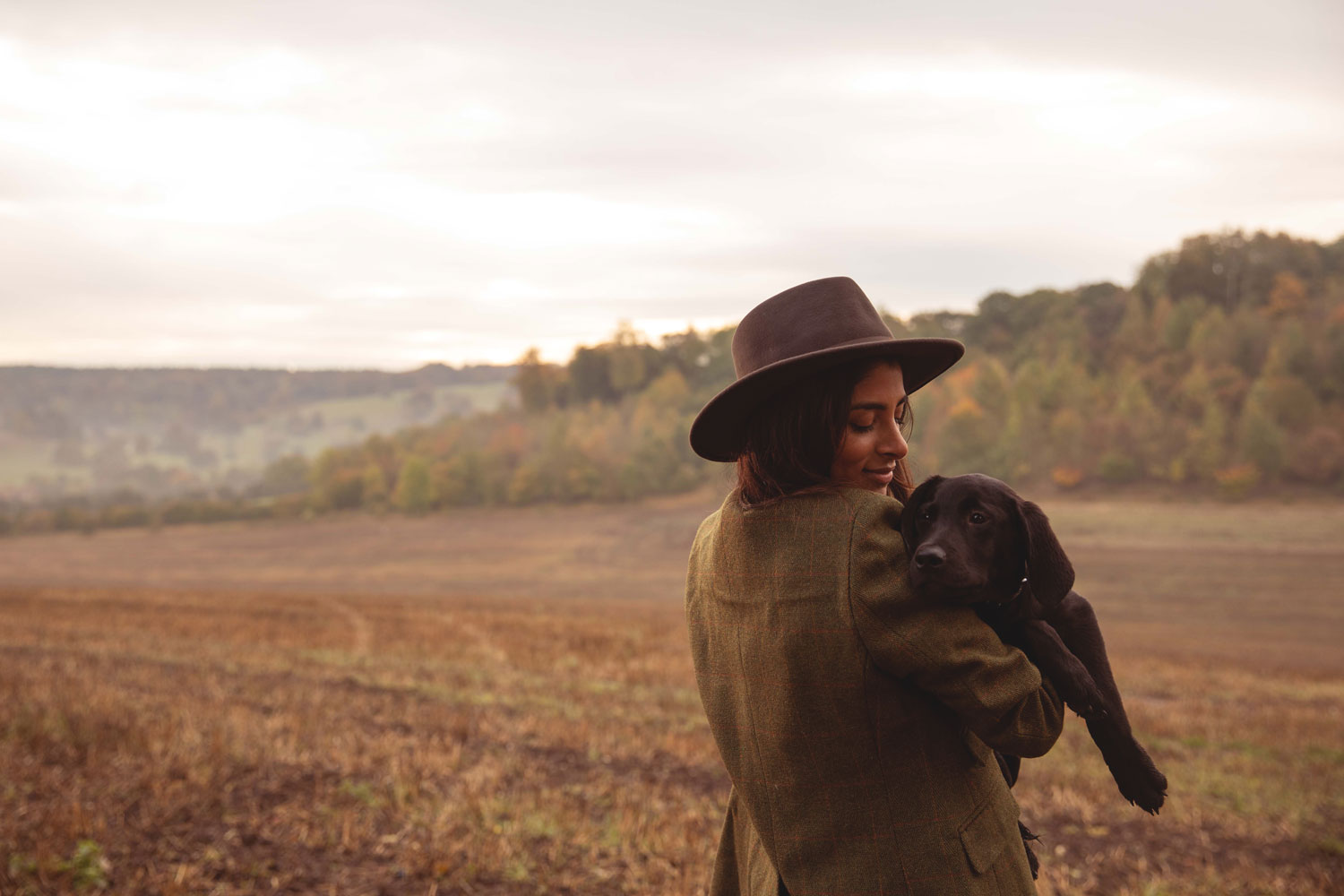 Woman hugging her puppy