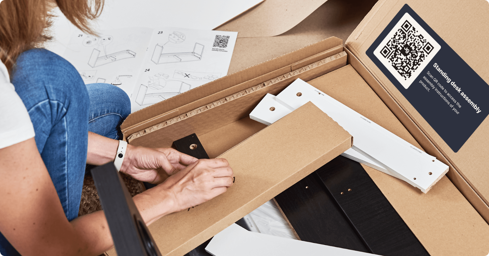 A flat pack piece of furniture with assembly instructions provided with a Jig QR code