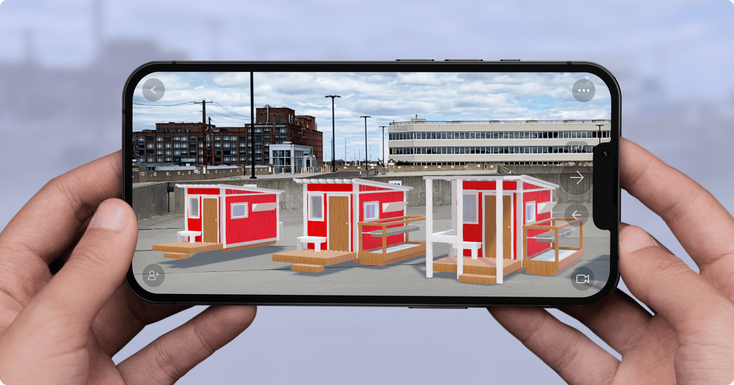 An iphone viewing three 3D tiny homes to scale in augmented reality using JigSpace
