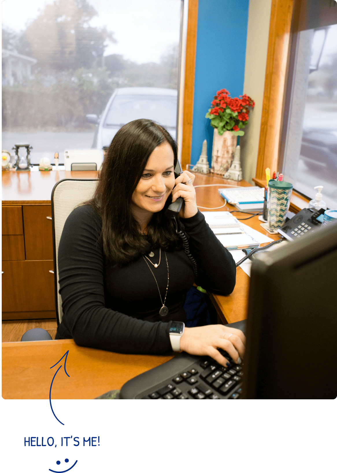 Melissa Ems talking with a customer on the phone while looking at her computer.