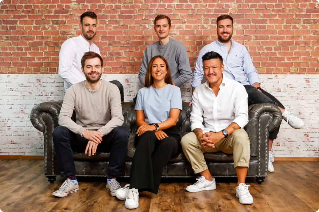 Capmo team sitting on a couch