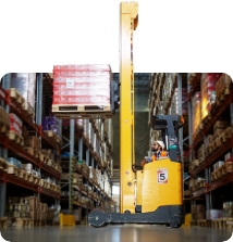 Forklift in warehouse lifting boxes