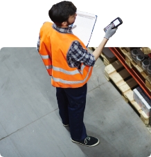 Storeman with rf scanner scanning boxes on a storage rack