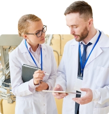 Senior manager talking to a college standing next to a food production line
