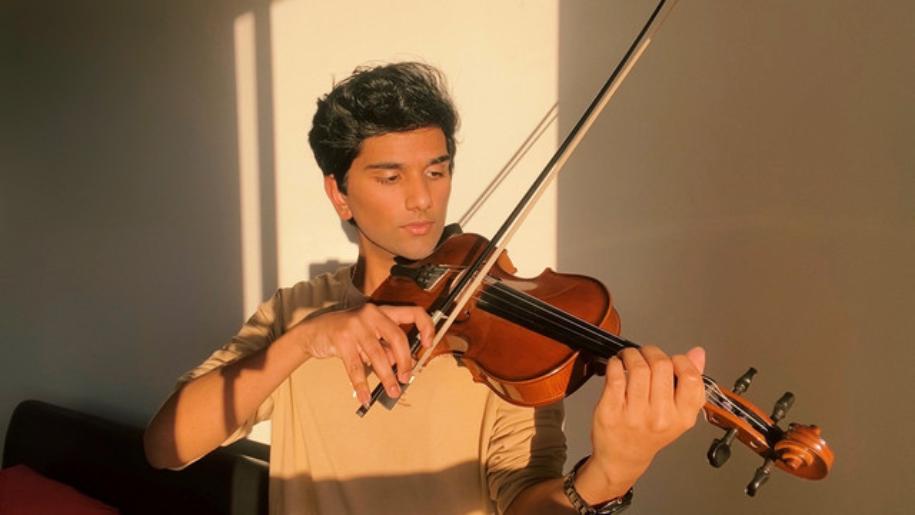 picture of a Joel Sunny holding a violin