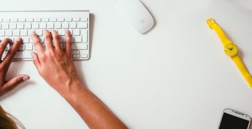 Writer's hands on computer keyboard.
