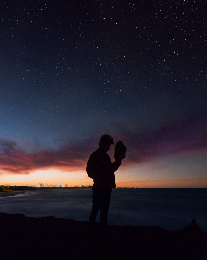 A man silhouetted by the sunset.