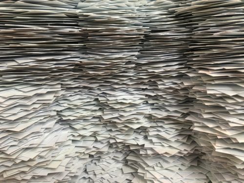 Multiple stacks of paper side by side and overlapping.
