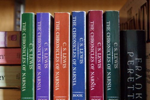 The Chronicles of Narnia children's book series sits on a bookshelf.