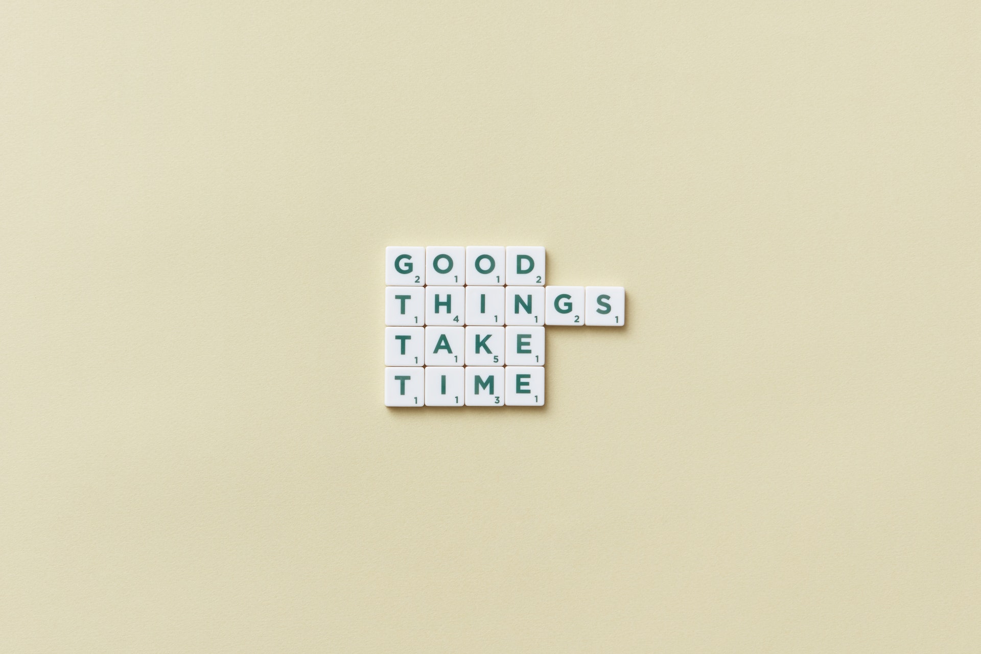 A theme spelled out in scrabble tiles: "Good things take time."