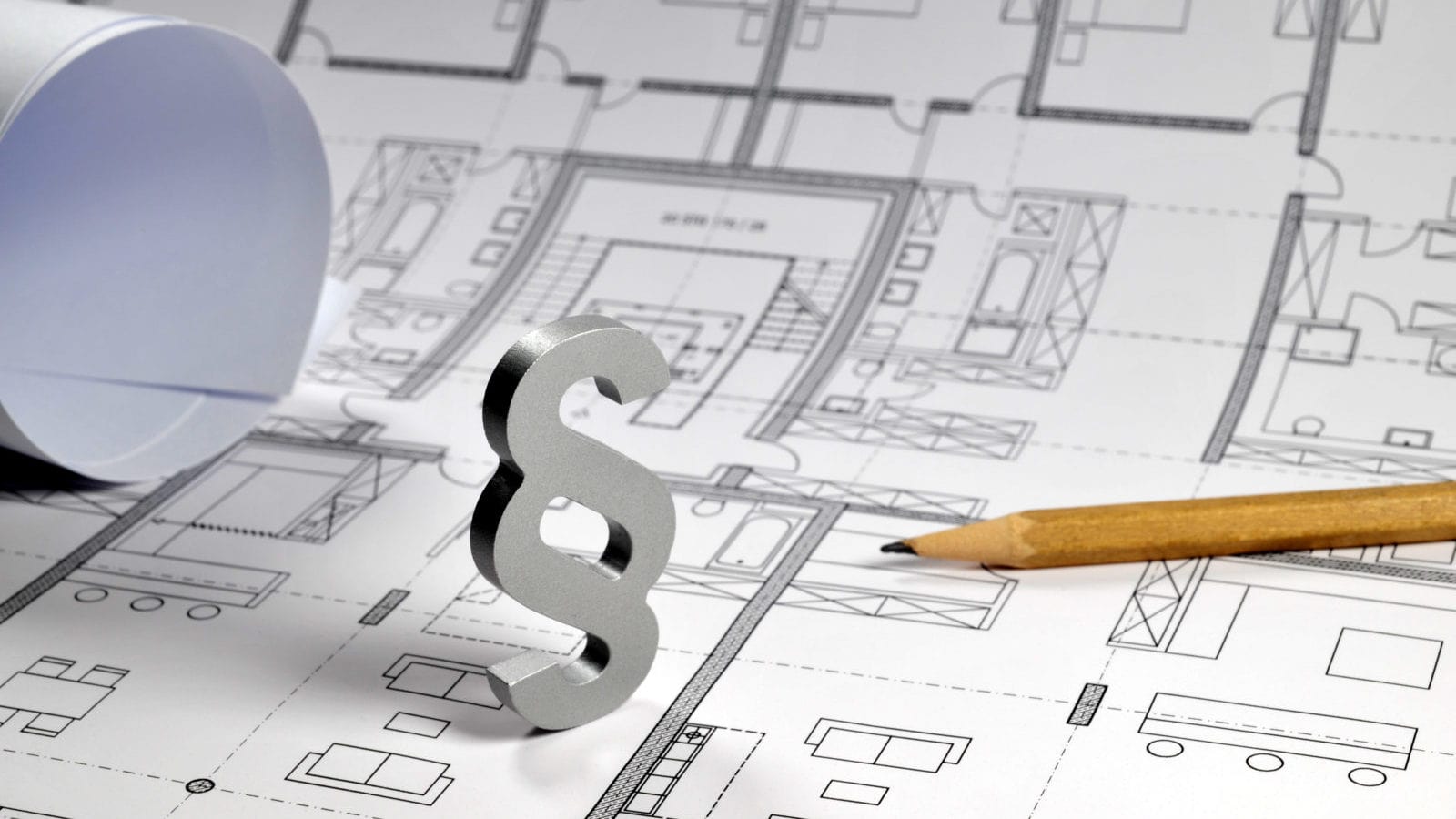 The picture of a paper with building model on it and a pencil