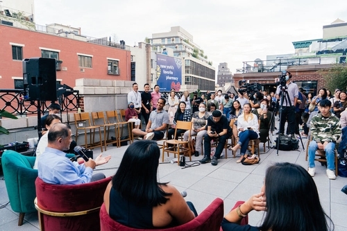 A group of people listening to speakers at an Empathy to Action panel.