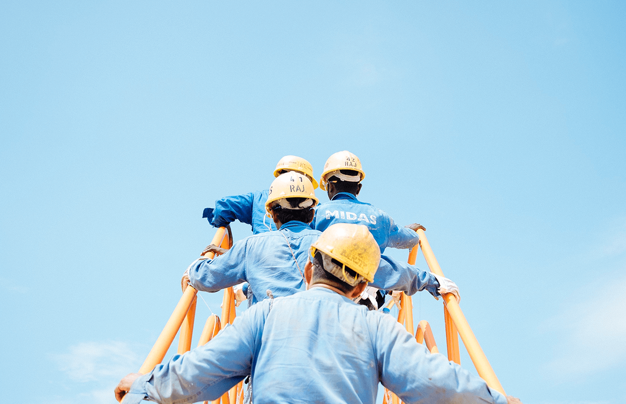 Construction workers walking upstairs to a job site.