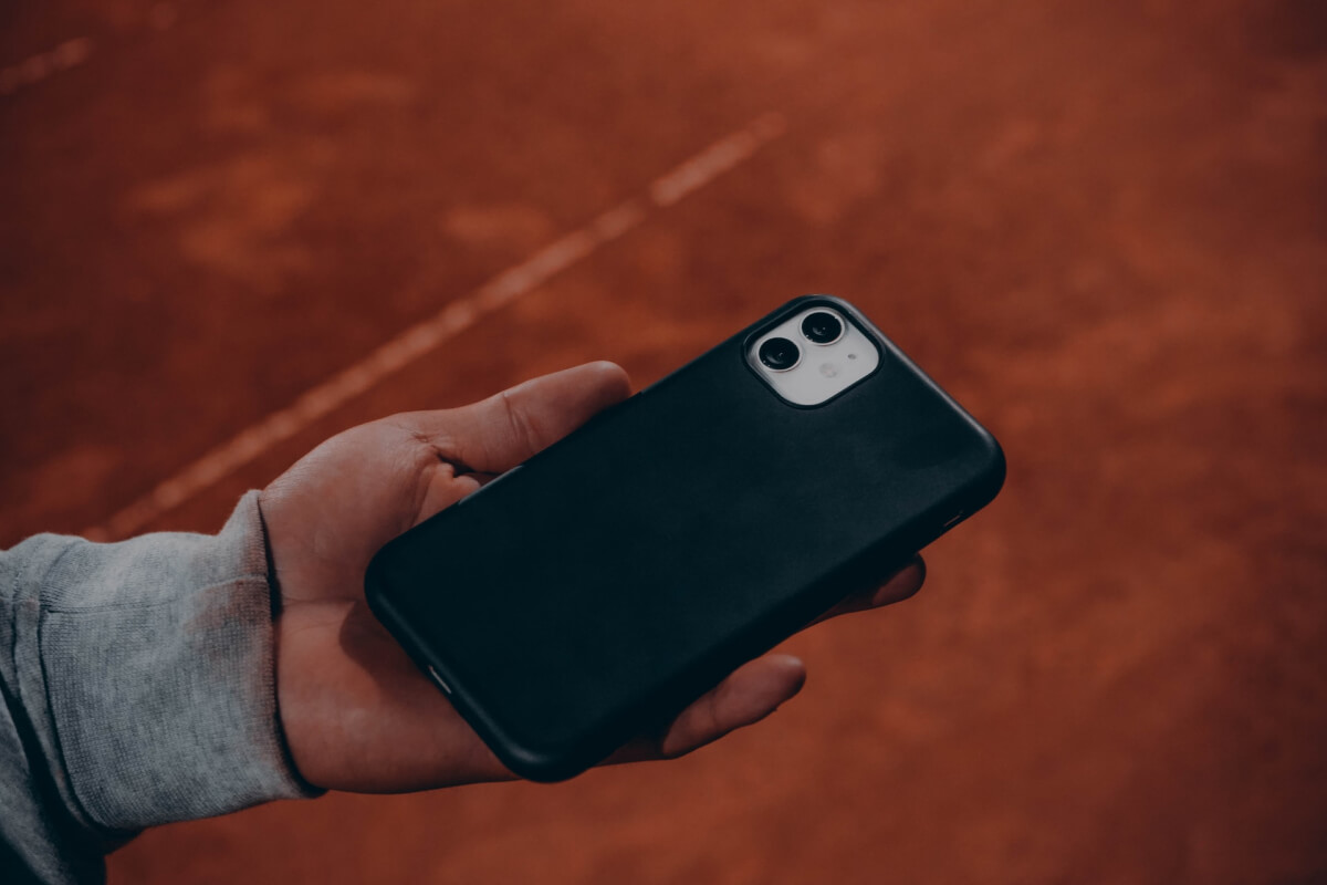 A man's hand holding a smart phone