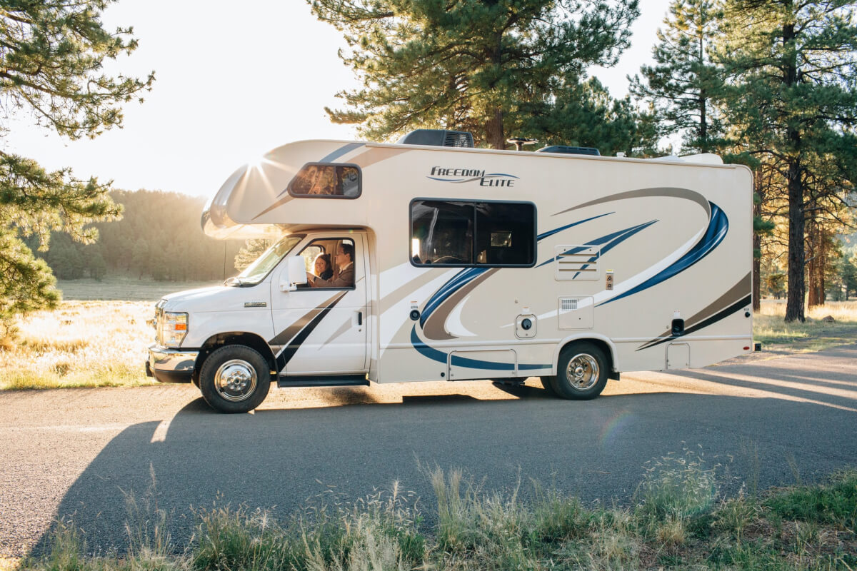 People driving an RV on the road.