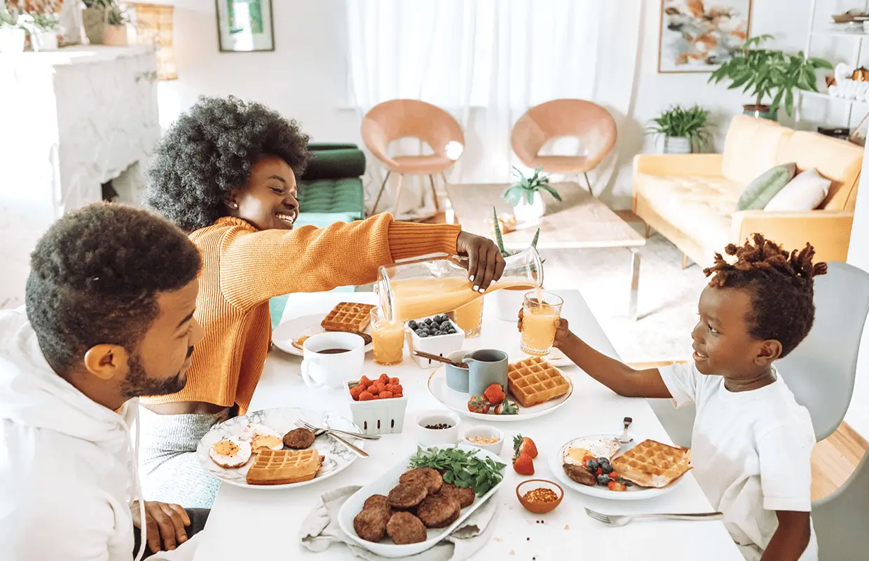 A family enjoys breakfast at their dining room table.