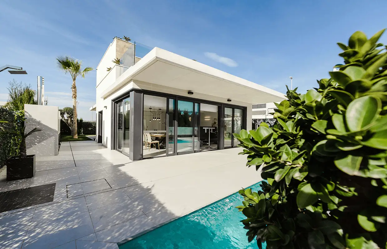 Home with pool and trees in the backyard.