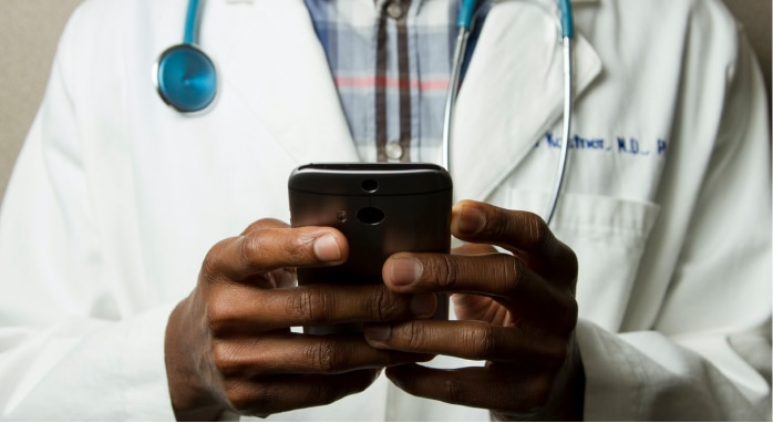 A doctor using his phone